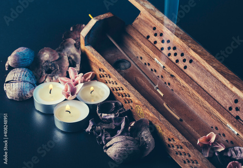 incense stick aroma with smoke  in a  holder with dried petals photo