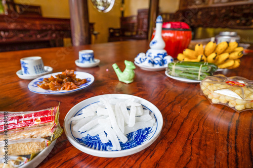 View of Vietnamese food for Tet holiday in spring, jam is traditional food and teapot set on lunar new year. Dried fruit and jam as tradition dessert - Mut Tet on wooden table. photo
