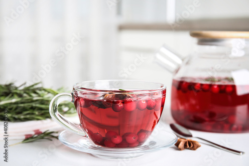 Tasty hot cranberry tea on white table