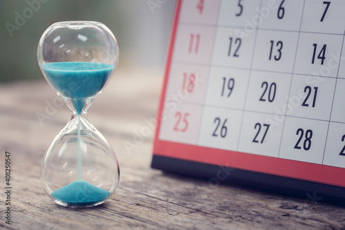 Hour glass and calendar important appointment date, schedule and deadline photo