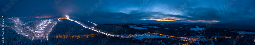 Panoramic cloudy sunset over the ski slopes of Levi, Kittilä, Finland.