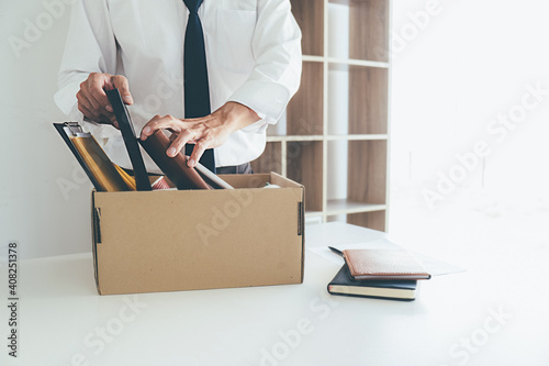 Sad dismissed businessman sitting outside the office after losing his job