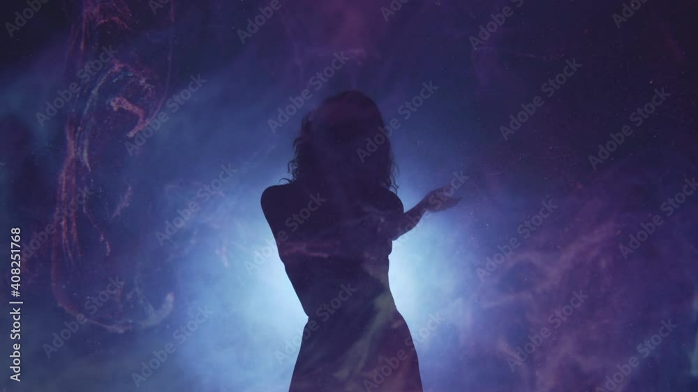 Silhouette woman. Tranquility dance performance. Magic spirituality. Graceful lady moving in haze shadow defocused spot neon light curved lines dark background slow motion copy space.