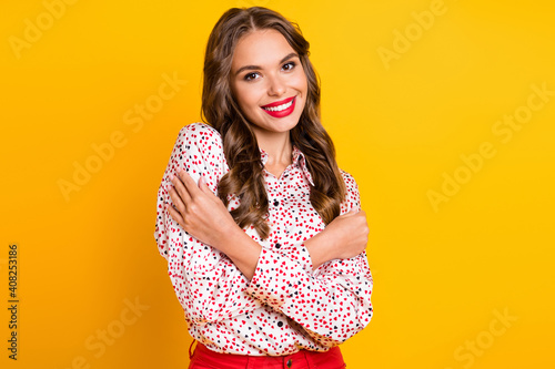 Photo of tender lovely girl embrace shoulders beaming smile wear heart print shirt isolated yellow color background