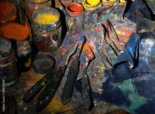 Acrylic paint cans and knives on the table