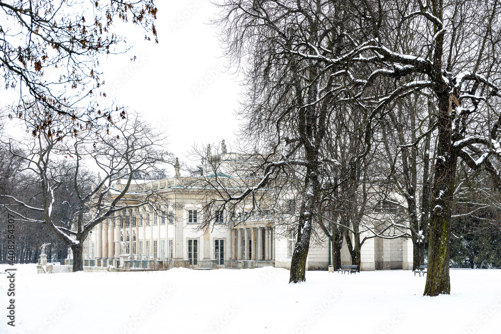 historic palace on the water in Łazienki Królewskie park in Warsaw, Poland during snowy winter