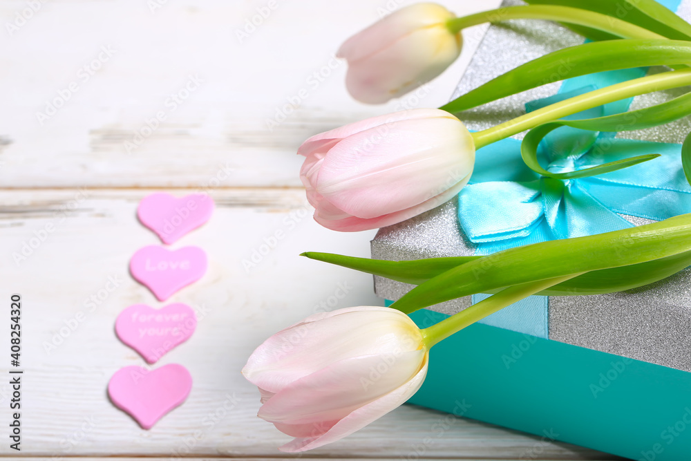 pink tulips with gift box on white wooden background. Valentine day romantic background. pink tulips with gift box on white wooden background. Valentine day romantic background.