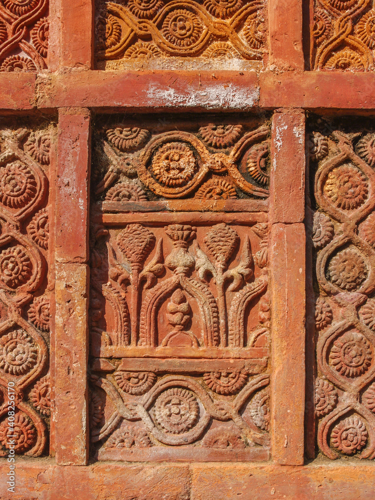 Detail of beautiful intricate terracotta carving with floral and geometric pattern on the facade of ancient Atiya or Atia mosque in Tangail district, Bangladesh Detail of beautiful intricate terracotta carving with floral and geometric pattern on the facade of ancient Atiya or Atia mosque in Tangail district, Bangladesh