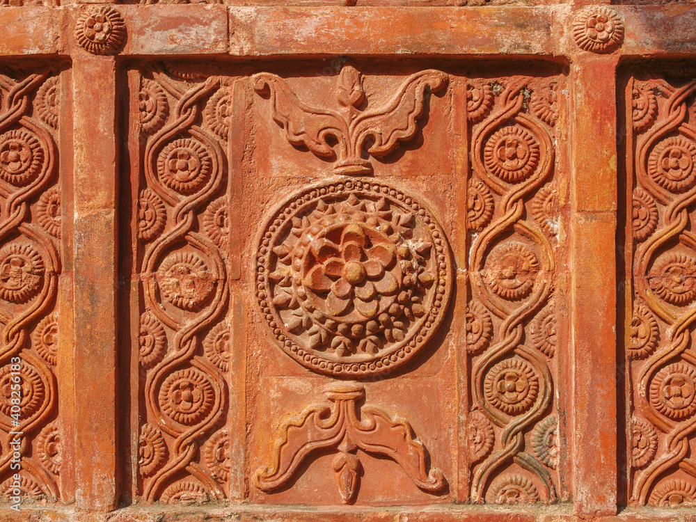 Detail of beautiful intricate terracotta carving with floral and geometric pattern on the facade of ancient Atiya or Atia mosque in Tangail district, Bangladesh