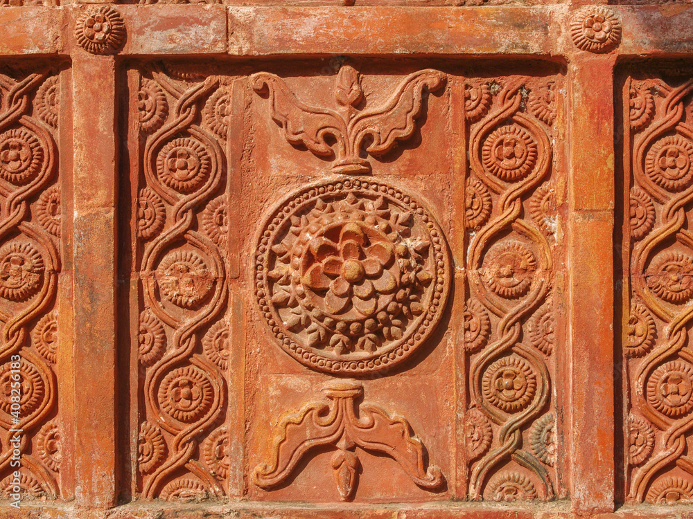 Detail of beautiful intricate terracotta carving with floral and geometric pattern on the facade of ancient Atiya or Atia mosque in Tangail district, Bangladesh Detail of beautiful intricate terracotta carving with floral and geometric pattern on the facade of ancient Atiya or Atia mosque in Tangail district, Bangladesh
