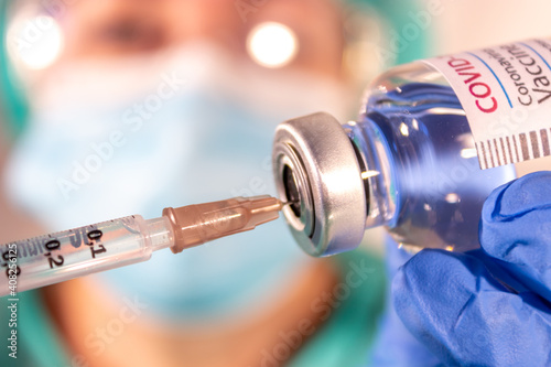 Female doctor prepares syringe and COVID-19 vaccine. Healthcare And Medical concept. Vaccination and immunization. Coronavirus.