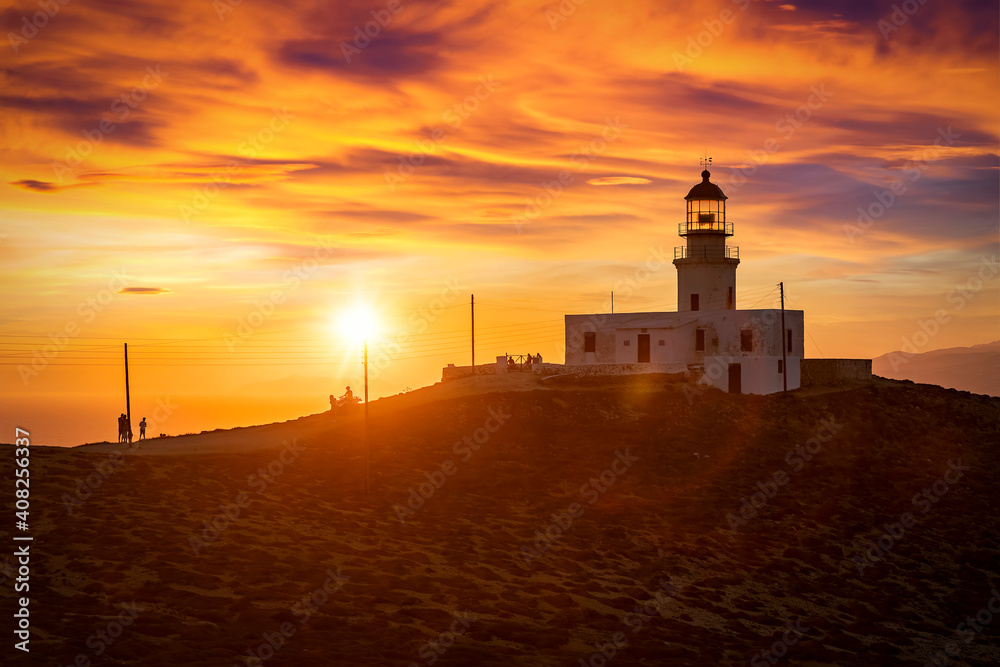 The popular Lighthouse Armenistis on the Greek island of Mykonos during sunset time The popular Lighthouse Armenistis on the Greek island of Mykonos during sunset time