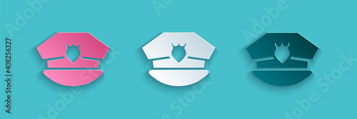 Paper cut Police cap with cockade icon isolated on blue background. Police hat sign. Paper art style. Vector.