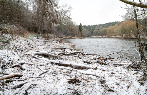 Snow covered drift wood after the floods on the River Teviot, Scottish Borders, UK photo