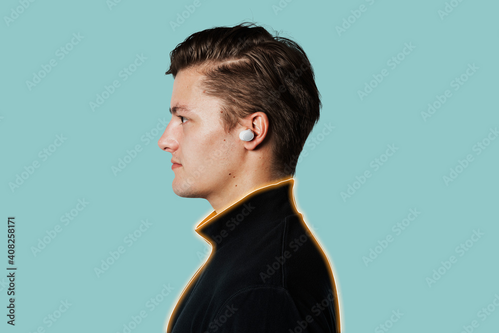 Wireless earbuds in young man's ear Wireless earbuds in young man's ear