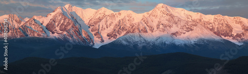 Panorama. Mountain peaks in dawn light. © Valerii