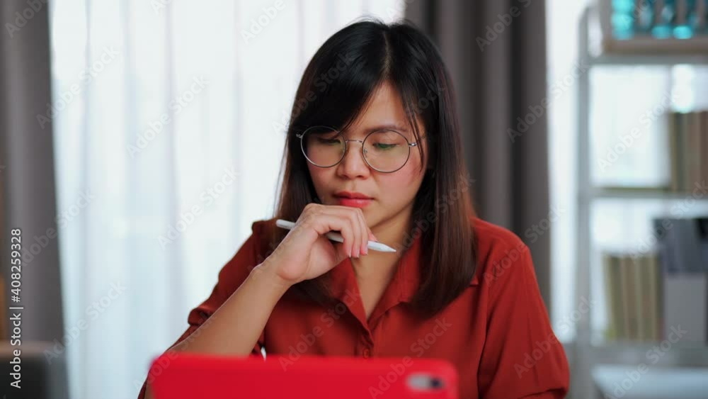 A young smart intelligent asian business working woman work as a secretary, manager, businesswoman, writer, student, and, employee wearing eyeglasses with a brick-red-orange long sleeve shirt. A young smart intelligent asian business working woman work as a secretary, manager, businesswoman, writer, student, and, employee wearing eyeglasses with a brick-red-orange long sleeve shirt.