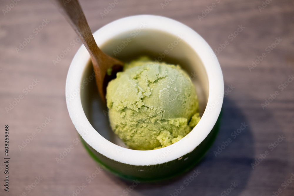 Green tea matcha ice cream scoop in bowl Green tea matcha ice cream scoop in bowl