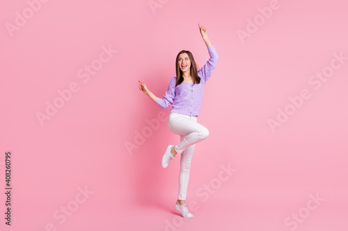 Full size photo of optimistic girl dance wear lilac sweater trousers sneakers isolated on pink color background