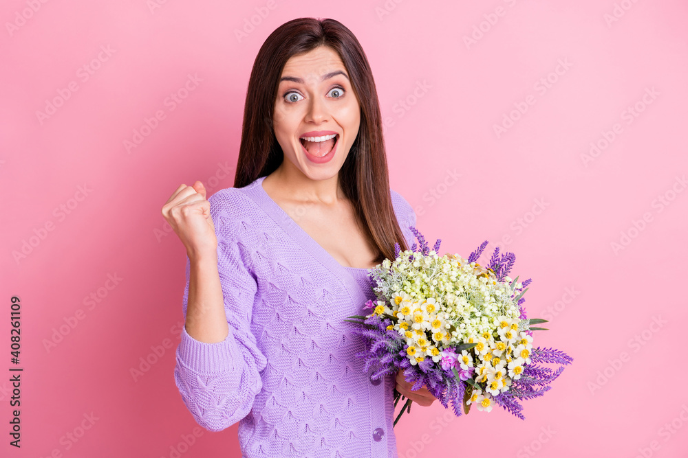 Photo of young excited girl happy smile hold bouquet celebrate win victory fists hand isolated over pink color background