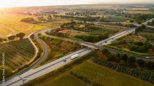 Aerial Drone View: Big Highway in Italy Surrounded by Farms, Agricutlural Plantations, Vegetable Growing Fields