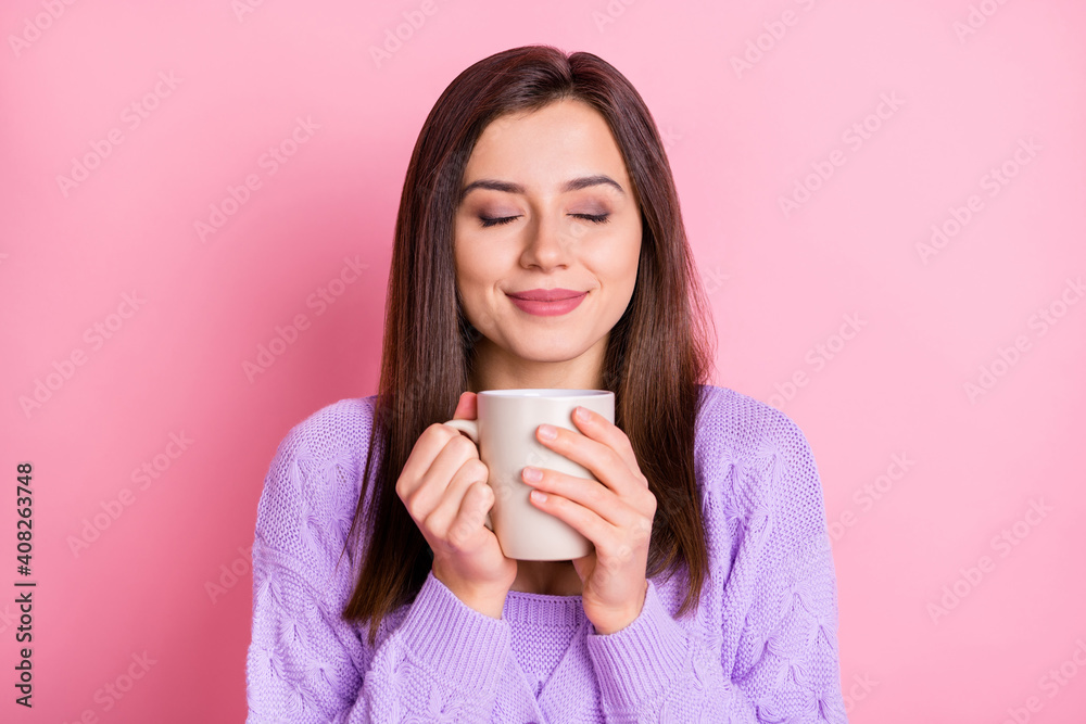 Portrait of optimistic girl hold cup closed eyes wear lilac sweater isolated on pink color background Portrait of optimistic girl hold cup closed eyes wear lilac sweater isolated on pink color background