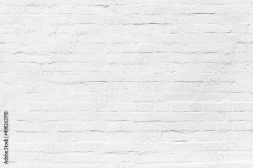 Brick wall with white plastering, seamless background