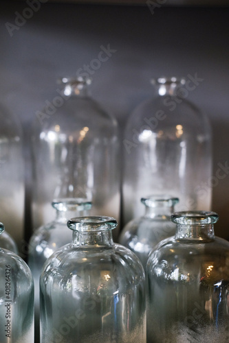 Decorative glass bottles on a shelf. Blue background