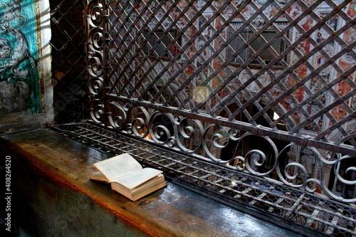 Palermo, Italy, September 03, 2017, Monastery of Santa Caterina, cloistered grates of the nuns for participation in mass with an open missal in the foreground