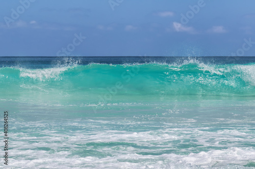 Sea wave in tropical beach background.
