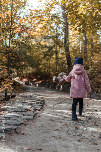 little girl walking in autumn park