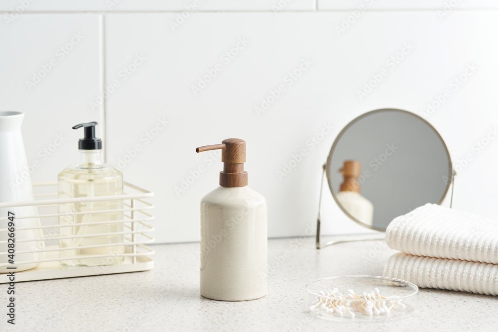 Reusable bottle of soap near hygienic supplies