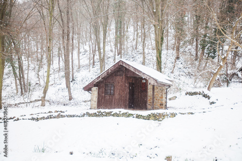 Wooden rural house , winter cold day. Beautiful snowy day in nature. © mitarart