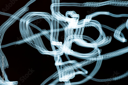 An abstraction. Numbers in motion. Turquoise on a black background. Dark background.