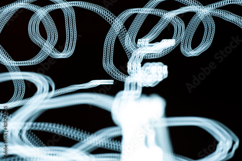 An abstraction. Numbers in motion. Turquoise on a black background. Dark background.