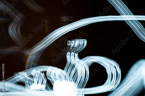 An abstraction. Numbers in motion. Turquoise on a black background. Dark background. 0:03. 0:04.