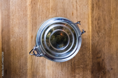 Cannabis jar from the top on a wooden table