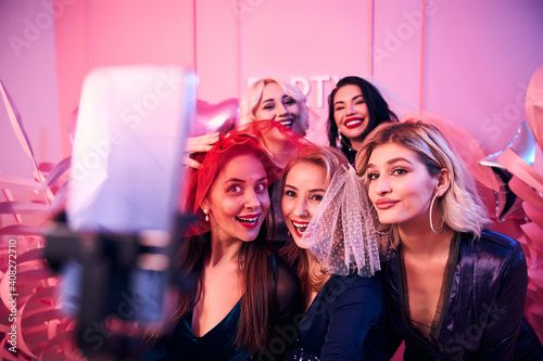 Bride-to-be photographing herself and friends using a selfie stick