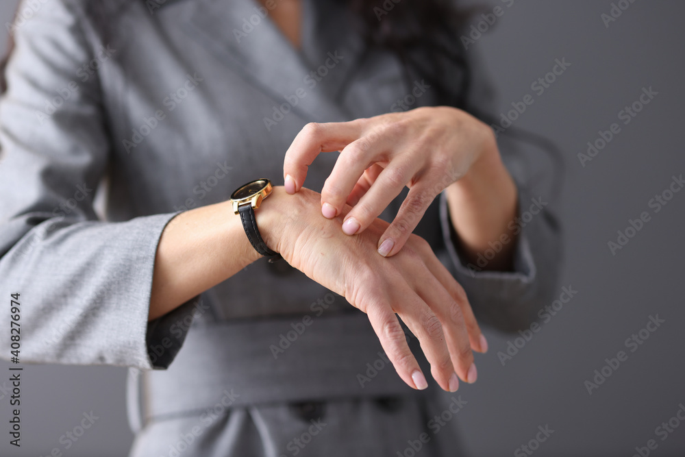 Woman scratches her hand with her nails
