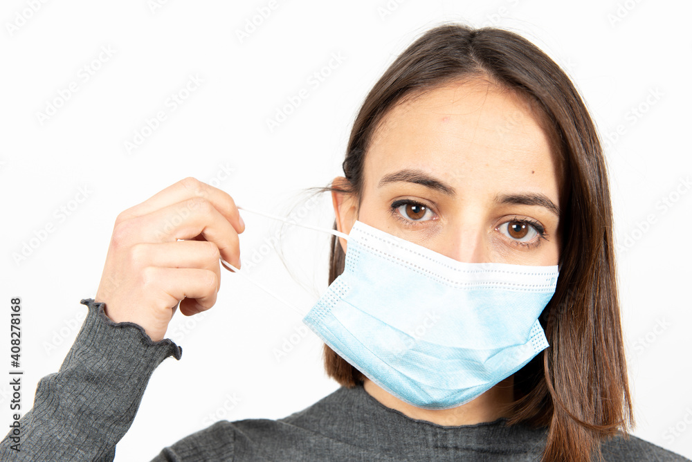 Latin woman taking off the medical face mask. Healthcare during Coronavirus pandemic concept. Latin woman taking off the medical face mask. Healthcare during Coronavirus pandemic concept.
