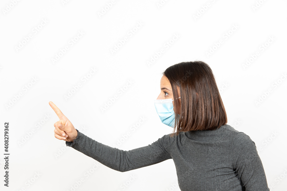 Serious latin woman wearing a surgical face mask commanding with authority. Healthcare during Coronavirus pandemic concept. Serious latin woman wearing a surgical face mask commanding with authority. Healthcare during Coronavirus pandemic concept.
