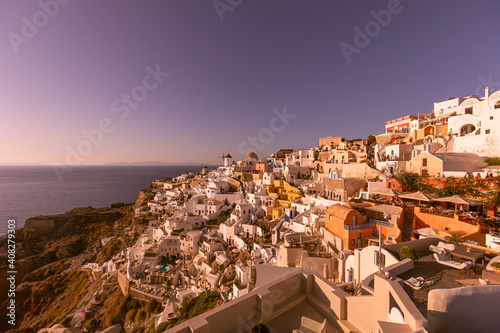 Amazing evening view of Santorini island. Picturesque spring sunset on the famous Greek resort Oia, Greece, Europe. Traveling concept background. Artistic style post processed photo. Summer vacation