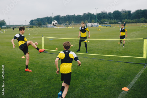 Obraz na plátně Young boys in youth soccer club playing football tennis training game