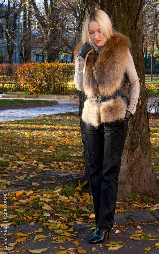 The girl in a fur coat walks around the city on a sunny day (poster mockup) The girl in a fur coat walks around the city on a sunny day (poster mockup)