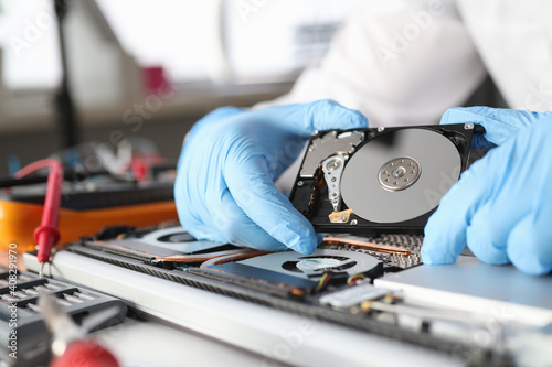 Gloved master holds a hard drive closeup