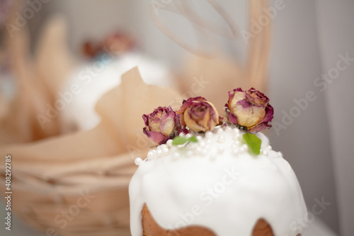 Traditional russian easter cake on table. The decorarion of kulich are the flower are eating on spring holiday photo