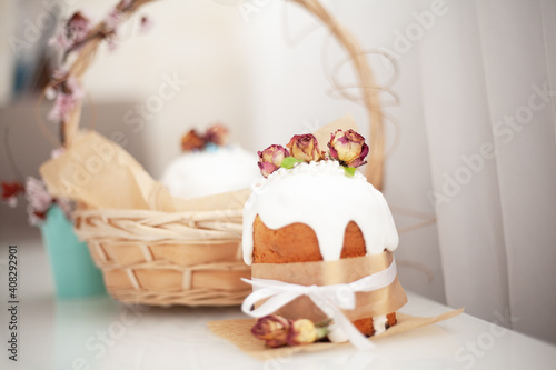 Traditional russian easter cake on table. The decorarion of kulich are the flower are eating on spring holiday photo
