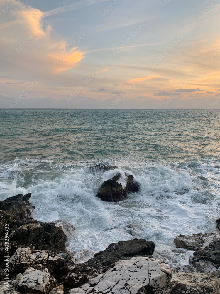 Sunset at the sea, rocky coastline, natural colors