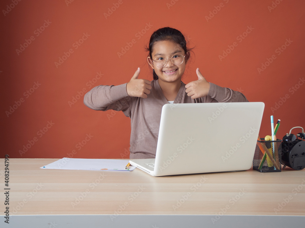 Little girl studying with laptop