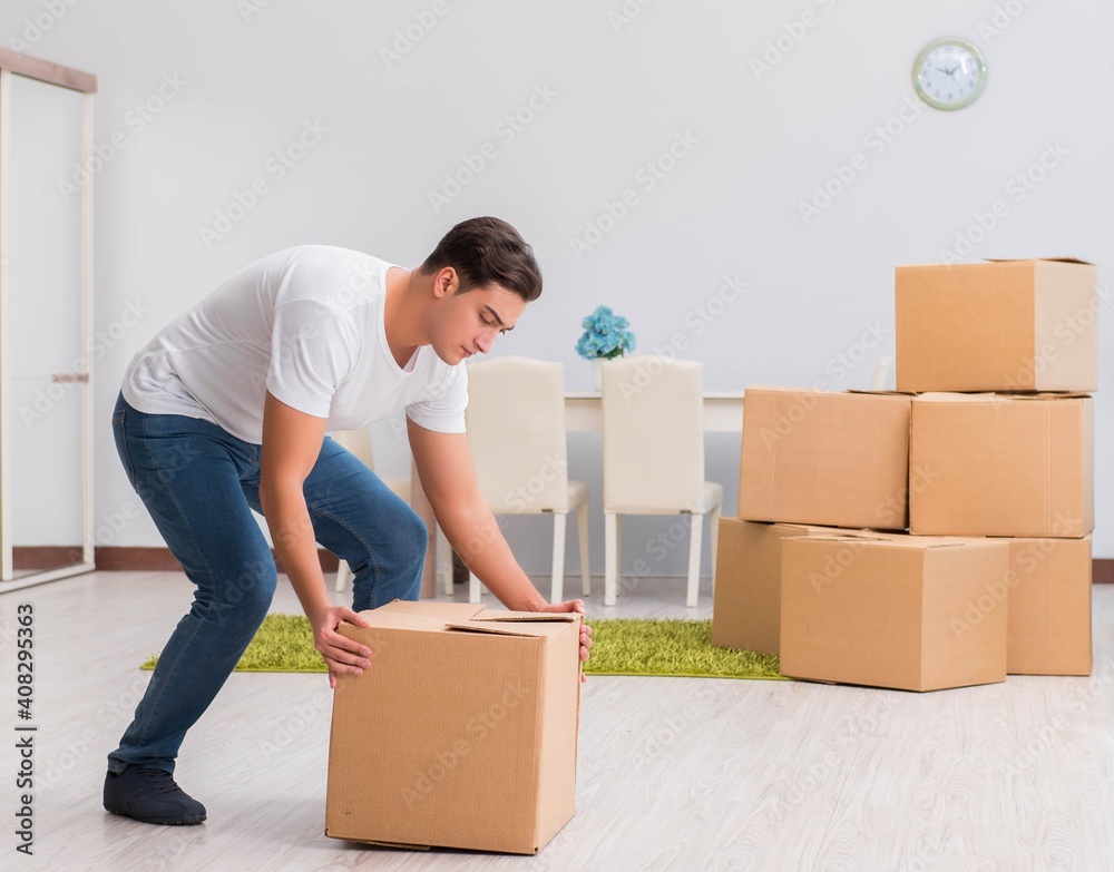 Man carrying boxes at home Man carrying boxes at home